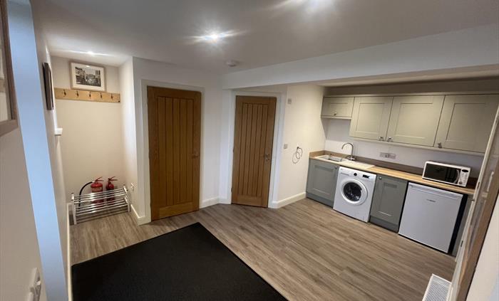 large utility room, washer dryer, microwave and freezer